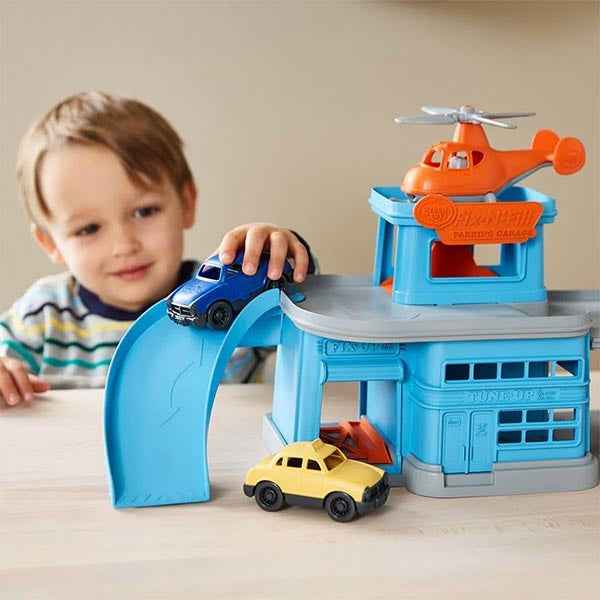 Green Toys parking garage with cars and helicopter