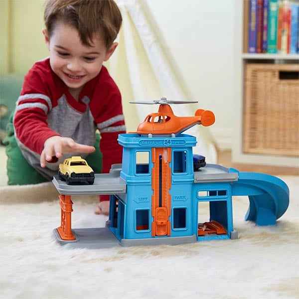 Green Toys parking garage with cars and a helicopter